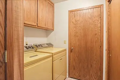 a small kitchen with a stove and a washer at Serene Tahoe Donner Cabin mins to Lake, Ski, Golf in Truckee