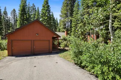 a house with a garage and a driveway at Serene Tahoe Donner Cabin mins to Lake, Ski, Golf in Truckee