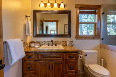 a bathroom with a sink and a toilet and a mirror at Kings Beach Family Retreat - Lake Views and Hot Tub in Kings Beach