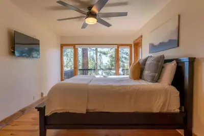 a bedroom with a bed with a ceiling fan at Kings Beach Family Retreat - Lake Views and Hot Tub in Kings Beach
