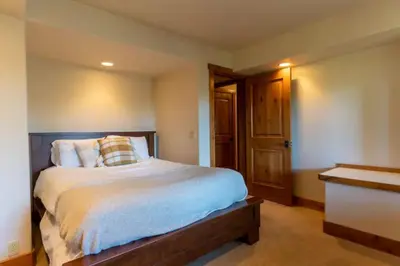 a bedroom with a large bed with a wooden headboard at Kings Beach Family Retreat - Lake Views and Hot Tub in Kings Beach
