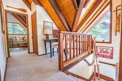 a home hallway with a wooden ceiling and a staircase at A-Frame Cabin - Hot Tub , BBQ , Family Fun in Tahoe Vista