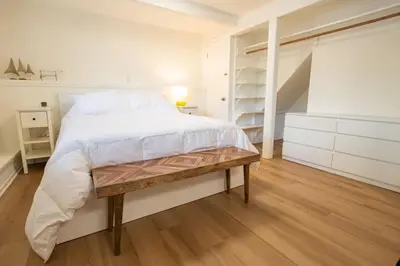 a bedroom with a large bed with a wooden bench at Welcoming Studio Walk to Palisades Resort and Lifts in Olympic Valley