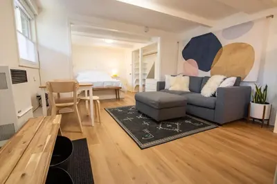a living room with a couch and a bed at Welcoming Studio Walk to Palisades Resort and Lifts in Olympic Valley