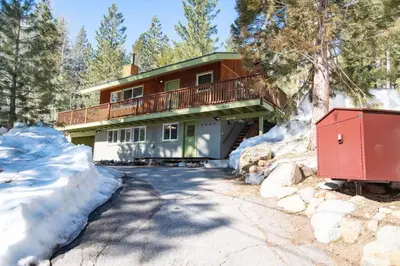 a house in the snow with a driveway at Welcoming Studio Walk to Palisades Resort and Lifts in Olympic Valley