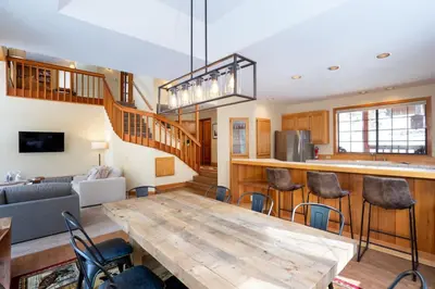 a kitchen and living room with a wooden table at Family Escape Minutes to Northstar EV Charger WandD in Truckee