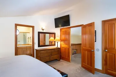 a bedroom with a bed and a tv on the wall at Family Escape Minutes to Northstar EV Charger WandD in Truckee
