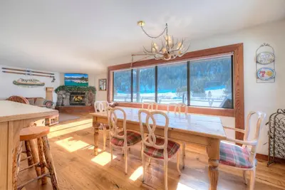 a dining room with a wooden table and chairs at Serene Condo by Palisades Base and Golf Course in Olympic Valley