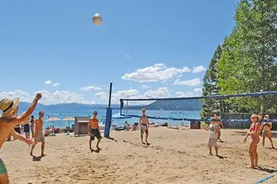 a group of people playing a game of volleyball on a beach at Idyllic Incline Village close to Lake Tahoe in Incline Village