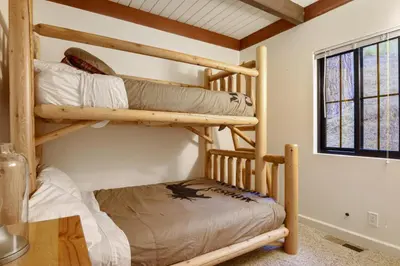 two bunk beds in a room with a table at Idyllic Incline Village close to Lake Tahoe in Incline Village