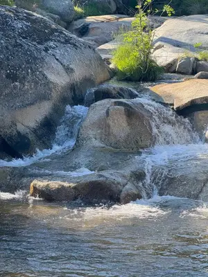 a stream of water on rocks in a river at Riverfront Serenity with Stunning Views in Mariposa