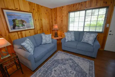 a living room with two couches and a table at Cozy Cabin with Boat Slip Winter SpecialEnds512 in Bass Lake