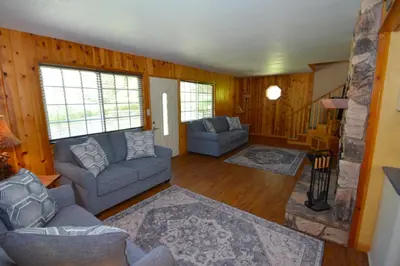 a living room with two couches and a fireplace at Cozy Cabin with Boat Slip Winter SpecialEnds512 in Bass Lake