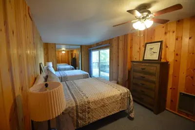 a bedroom with a bed and a ceiling fan at Cozy Cabin with Boat Slip Winter SpecialEnds512 in Bass Lake