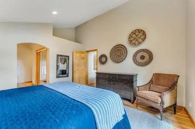 a bedroom with a blue bed and a chair at Chestnut Haus at Tahoe Donner By Tahoe Getaways - 4 BR w HOA Amenities in Truckee