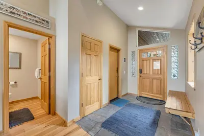 a hallway with two wooden doors and a blue rug at Chestnut Haus at Tahoe Donner By Tahoe Getaways - 4 BR w HOA Amenities in Truckee