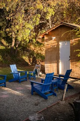 a group of blue chairs and a shed at Modern A Frame,20min Yosemite,Sunset View, PetOkay in Oakhurst