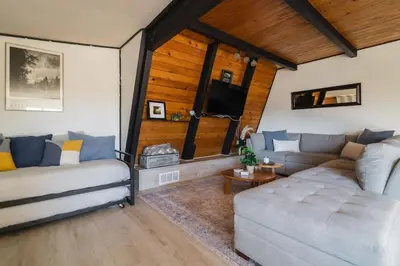 a living room with two couches and a tv at Modern A Frame,20min Yosemite,Sunset View, PetOkay in Oakhurst