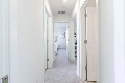 a hallway with white walls and white doors at Spacious 4BR-3BA Cozy and Modern in Elk Grove in Elk Grove