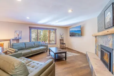 a living room with a couch and a fireplace at Tranquil Stay Sauna, Rooftop and Nature Views in Incline Village