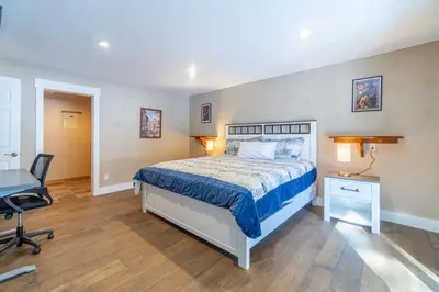 a bedroom with a bed and a desk and a chair at Tranquil Stay Sauna, Rooftop and Nature Views in Incline Village