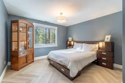 a bedroom with a large bed and a window at Tranquil Stay Sauna, Rooftop and Nature Views in Incline Village