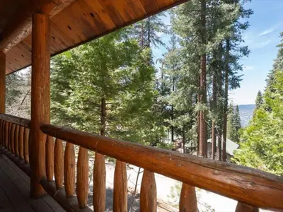 a porch of a cabin with a view of trees at Yosemite Log Cabin-Rustic Charm-Sleeps 8 in Yosemite West
