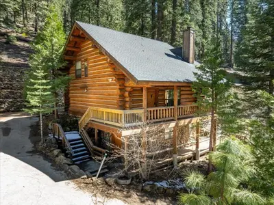 a log cabin in the middle of a forest at Yosemite Log Cabin-Rustic Charm-Sleeps 8 in Yosemite West