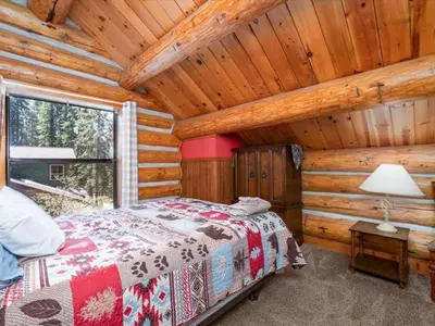 a bedroom with a bed in a log cabin at Yosemite Log Cabin-Rustic Charm-Sleeps 8 in Yosemite West
