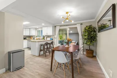 a kitchen and dining room with a table and chairs at MtnCity Views 4BR Firepit FamilyRetreat NearUNR in Reno