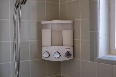 a soap dispenser in a shower in a bathroom at MtnCity Views 4BR Firepit FamilyRetreat NearUNR in Reno