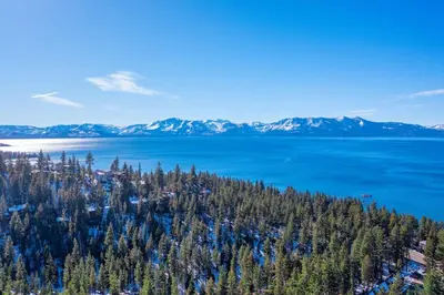 an aerial view of a lake with trees and mountains at Elegant Tahoe Escape Comfort and Style Combined in Glenbrook