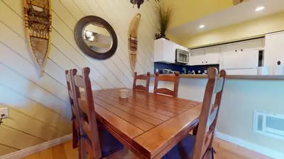 a dining room with a wooden table and chairs at Bigwood #30 condo in Mammoth Lakes