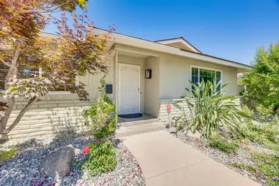 a house with a white door and a sidewalk at Shop, Hike and Explore Fresno Home with Private Pool! in Fresno