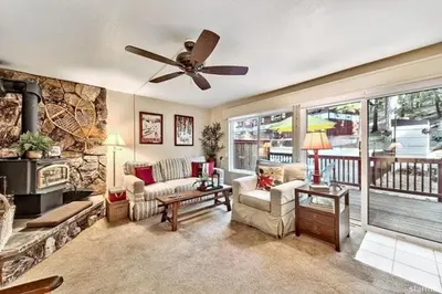 a living room with a couch and a ceiling fan at 1510 Wildwood, Sitzmark 4 home in South Lake Tahoe