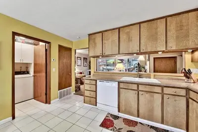 a large kitchen with wooden cabinets and white appliances at 1510 Wildwood, Sitzmark 4 home in South Lake Tahoe