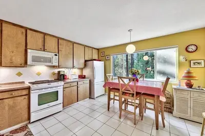 a kitchen with a table and chairs and a kitchen with at 1510 Wildwood, Sitzmark 4 home in South Lake Tahoe