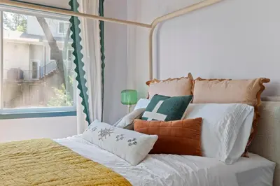 a bedroom with a bed with pillows and a window at Yosemite family getaway w lake, golf, horses, pool in Groveland