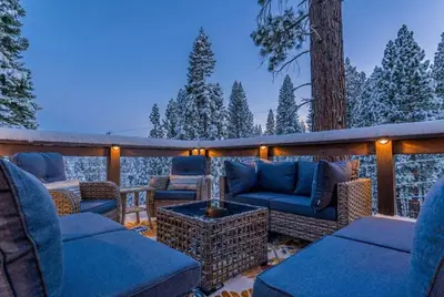 a patio with couches and a table and a tree at Agate Bay Getaway with Lake Views in Carnelian Bay