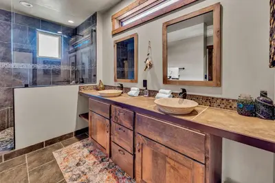 a bathroom with two sinks and a mirror at Agate Bay Getaway with Lake Views in Carnelian Bay