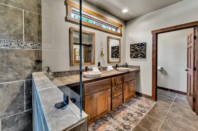 a bathroom with two sinks and a shower at Agate Bay Getaway with Lake Views in Carnelian Bay