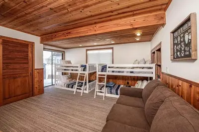 a living room with a couch and bunk beds at 625 Alpine Drive home in South Lake Tahoe