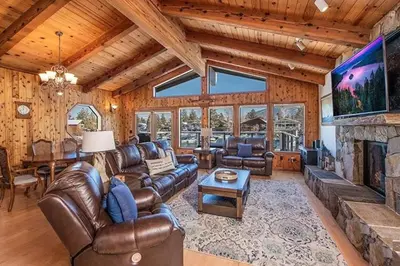 a living room with leather furniture and a fireplace at 625 Alpine Drive home in South Lake Tahoe
