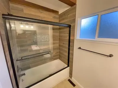 a glass shower in a bathroom with a window at 2708 Springwood Drive cabin in South Lake Tahoe