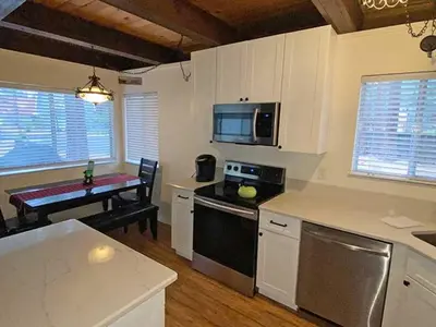 a kitchen with a table and a stove top oven at 2708 Springwood Drive cabin in South Lake Tahoe