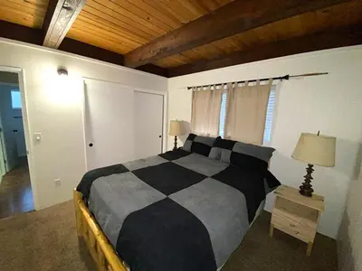 a bedroom with a bed and a wooden ceiling at 2708 Springwood Drive cabin in South Lake Tahoe