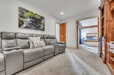 a living room with a couch and a television at Homewood Hideaway Family Friendly plus EV Charger in Homewood