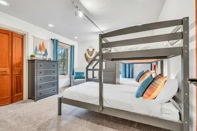 a bedroom with a bunk bed and a dresser at Homewood Hideaway Family Friendly plus EV Charger in Homewood