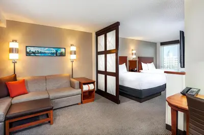 a hotel room with a couch and a bed at Hyatt Place Sacramento Roseville in Roseville
