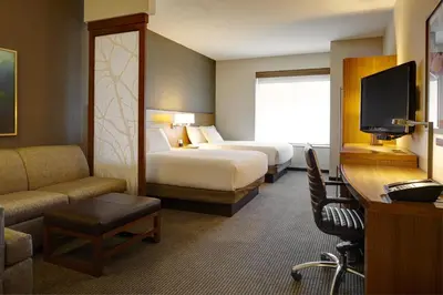 a hotel room with two beds and a television at Hyatt Place Sacramento Roseville in Roseville